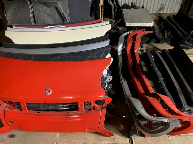 Smart Car wheels and other parts displayed on a table